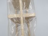 a wooden chair that is wrapped in plastic