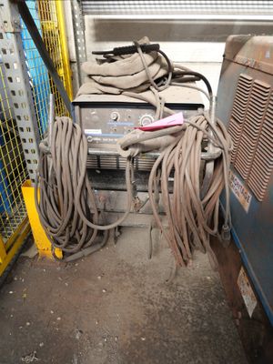 an image of a bunch of wires and a machine in a garage