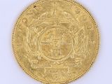 l'image d'une pièce d'or sur laquelle figurent des armoiries