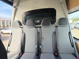 two seats in the back of a van with a view of a parking lot