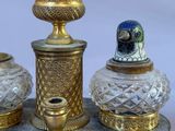 three glass vases sitting on top of a wooden stand