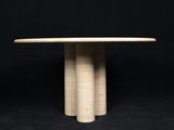 a white marble table with three columns on a black background