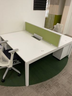 a desk with a chair and a computer monitor on it