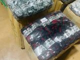 many bags of clothing sitting on the floor in a store
