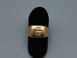 an image of a gold ring on a black velvet ring holder