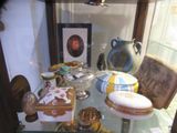 a glass display case with a cake and other items on it