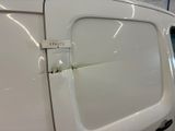 a close up of a white van door with a sticker on it