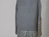 the back of a gray coat with a white and black pattern on it