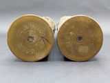 pair of antique brass candlesticks on a grey background