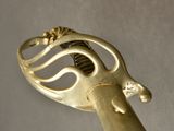 a close up of a metal object with a gold handle