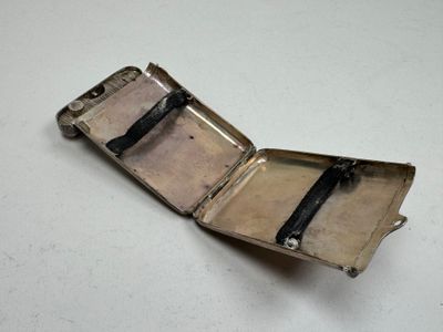 a silver case with a black handle on a table