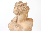 a statue of a woman wearing a dress on a white background