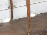 an image of a small wooden table on a hard wood floor