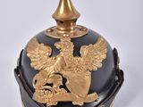 an image of a black and gold helmet with a golden eagle on it