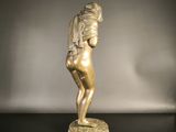bronze statue of a woman with a towel on her head on a black table