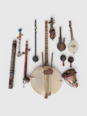 many different musical instruments arranged together on a white surface