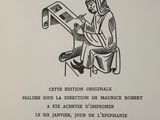 an old book with a drawing of a person sitting on a chair