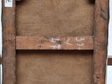 an old wooden frame with a sign on it sitting on top of a wooden floor