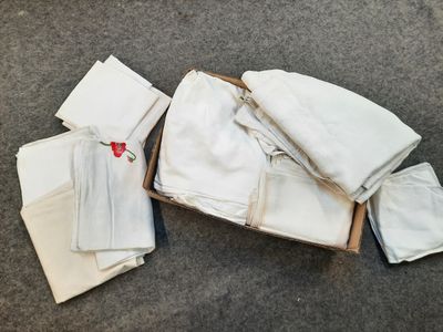 a box full of folded white towels on the floor