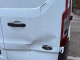 a white van that has been vandalized and is parked in a parking lot