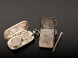 a small silver case with two coins inside of it