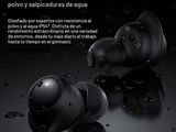 a pair of black earphones sitting on top of a black surface