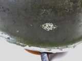a close up of a helmet on a stand on a table