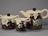 three ceramic teapots with cartoon characters on them sitting next to each other