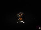an image of a close up of a ring on a black surface