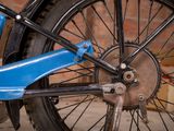 a close up of a blue bike with a black tire