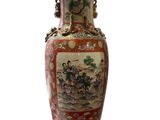 a vase with a painting on it sitting on a white surface