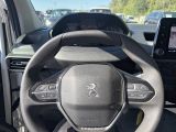 the steering wheel of a car is shown in a parking lot