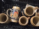 many cups and mugs sitting on a shelf in a basket