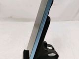 a cell phone that is on a stand on a table