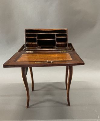 an old desk with a wooden top and a drawer on it