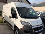 the white van is parked in front of a house with a mountain in the background