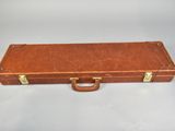 an old brown suitcase sitting on top of a white table