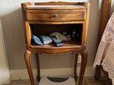 a small wooden table with a drawer on top of it