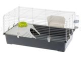 une cage blanche et noire avec un bol vert et une assiette blanche
