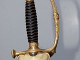 a gold and black sword with a black handle