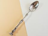 a spoon that is sitting on top of a yellow and white table