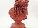 a close up of a statue of a man with a beard on a pedestal