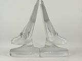 a pair of clear glass swan bookends on a white background