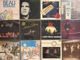 many different album covers on the wall of a room