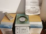 a microwave oven sitting on top of a table next to a remote control