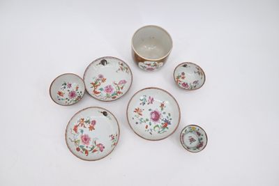 une image représentant un ensemble d'assiettes et de tasses en porcelaine posées sur une surface blanche
