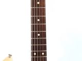 an electric guitar sitting on top of a white surface