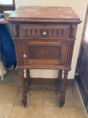 a small wooden table with a drawer on top of it