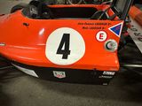 an orange race car with a number 4 on it
