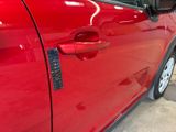 a close up of a car door handle with a sticker on it